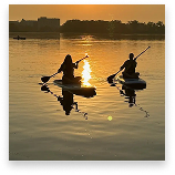 People on kayaks in the sunset